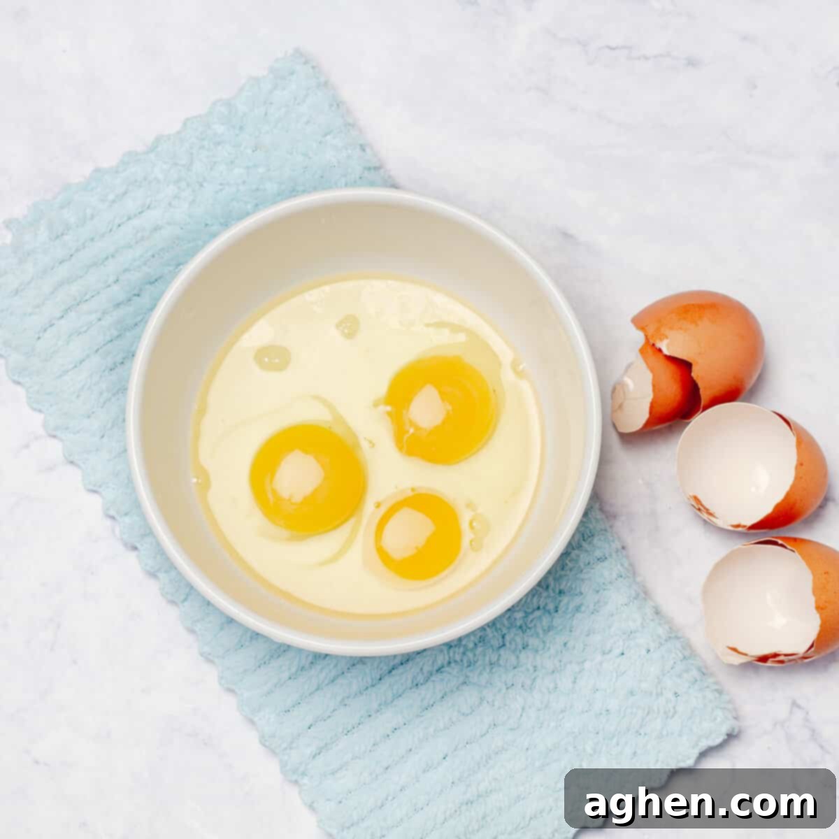 Three beaten eggs in a bowl