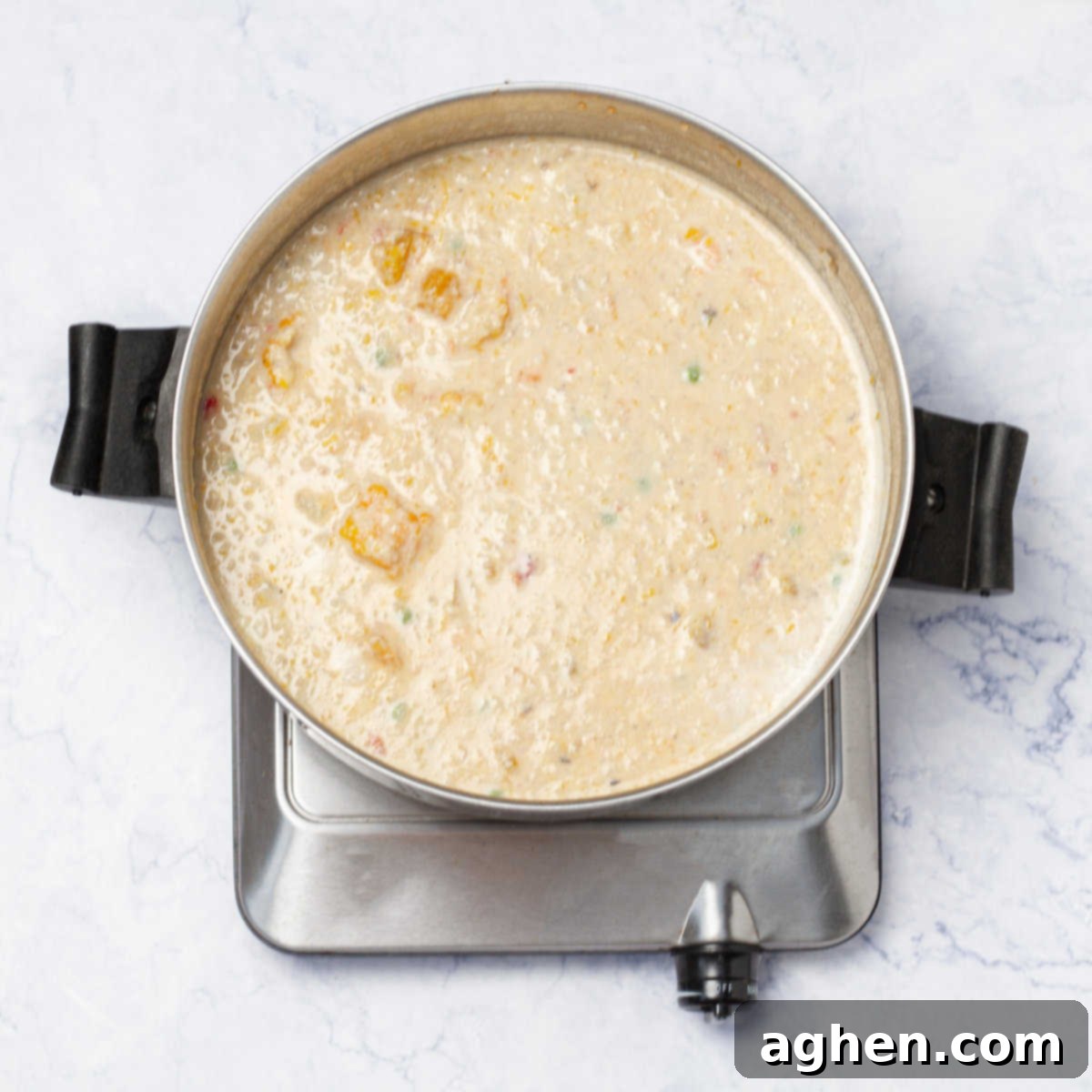 Chupe de Camarones cooking in a pan, with shrimp and creamy broth