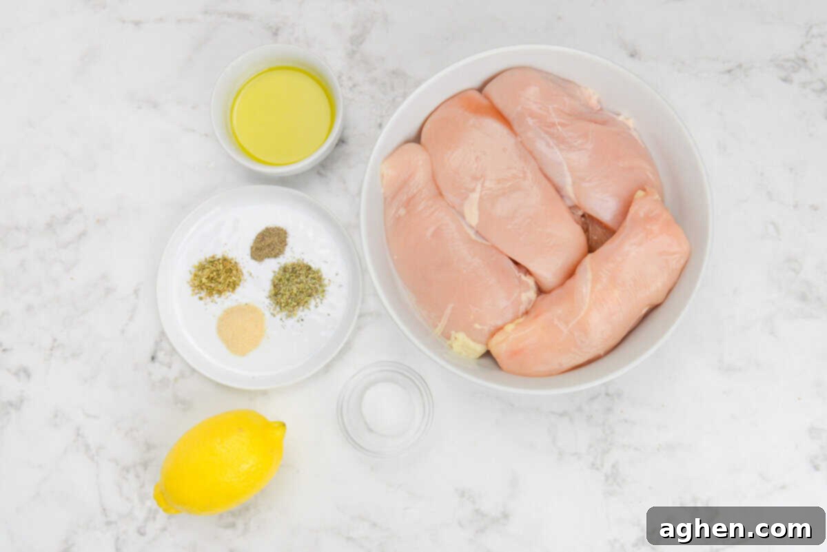 The Secret to Juicy Chicken Breasts on Your Blackstone 3 The ingredients to make Blackstone Chicken breast are placed in small bowls next to the raw chicken. The spices are placed on a small white plate