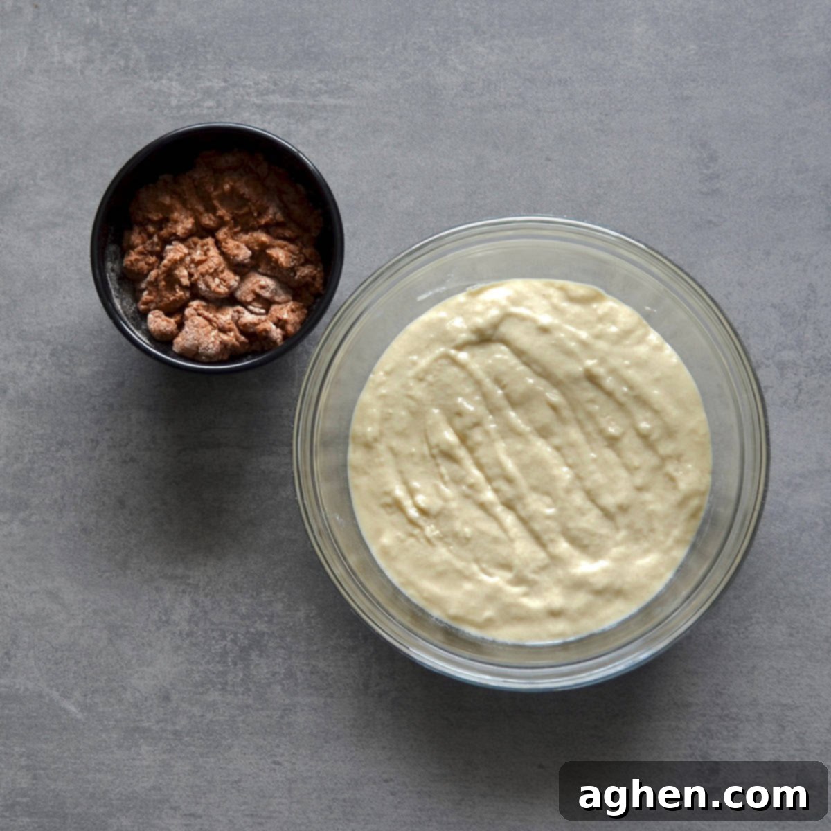 Indulge in Slow Cooker Coffee Cake The Weight Watchers Way 4 Coffee cake batter spread evenly in a slow cooker, next to a bowl of prepared streusel topping, ready for the next baking stage.