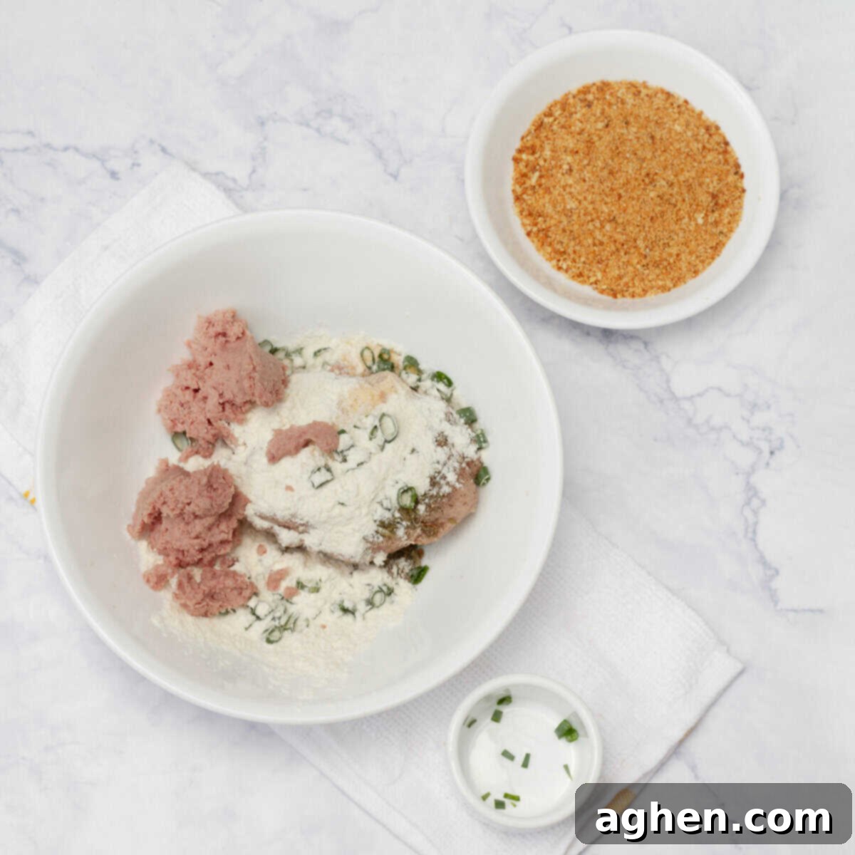 Wow Your Brunch Guests with Weight Watchers Scotch Eggs 6 A large bowl containing mixed ground pork and smoked turkey sausage, seasoned with scallions and spices, next to bowls of flour and breadcrumbs.