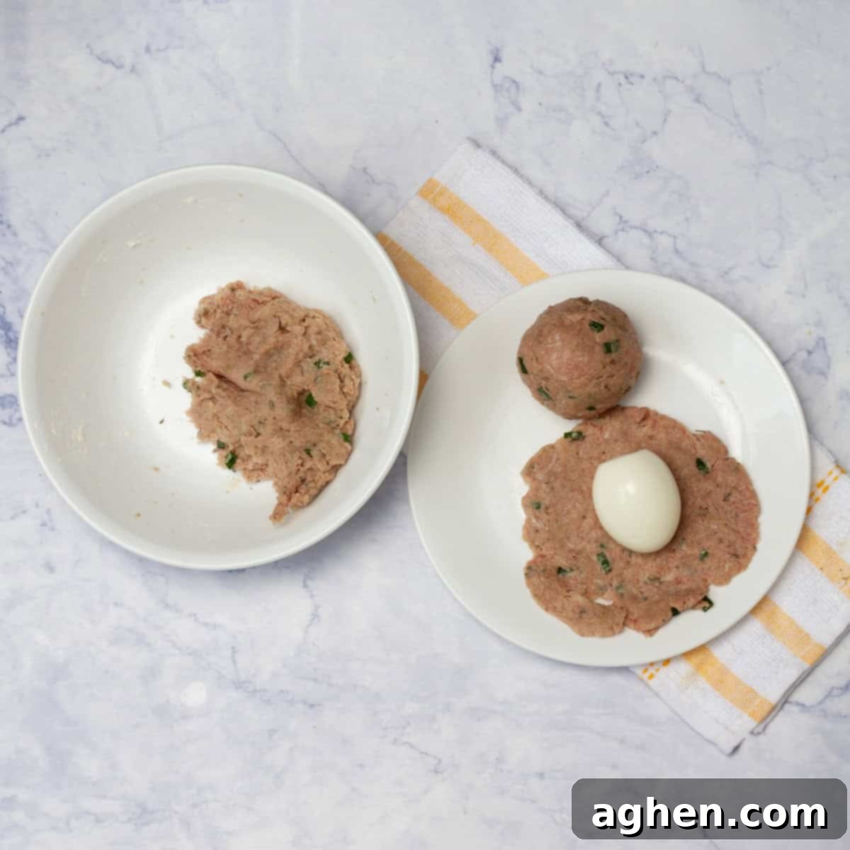 Wow Your Brunch Guests with Weight Watchers Scotch Eggs 7 A hard-boiled egg being carefully encased in a portion of the seasoned pork mixture, with the remaining mixture in a bowl.