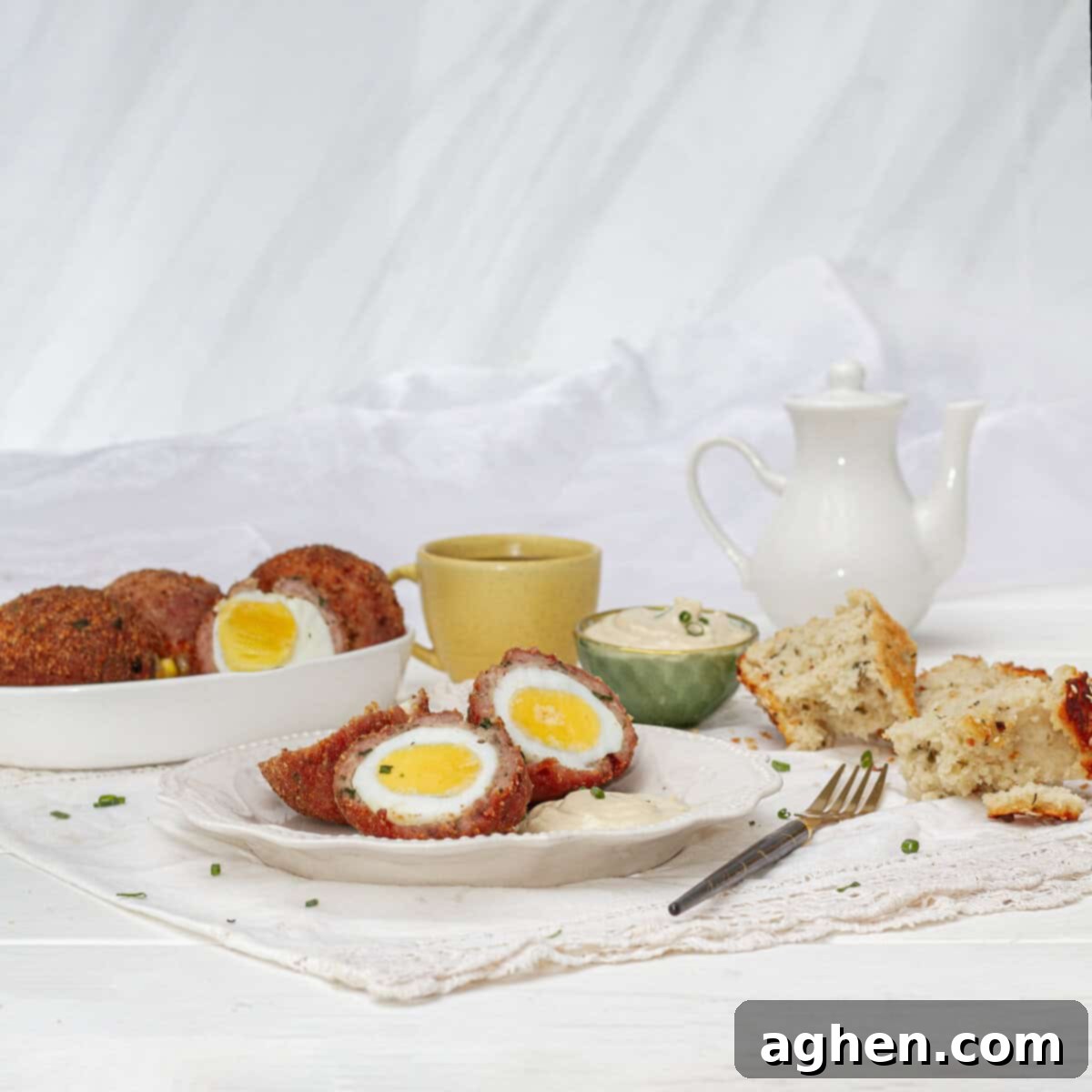 Wow Your Brunch Guests with Weight Watchers Scotch Eggs 9 Freshly cooked Air Fryer Scotch Eggs, sliced in half to reveal a perfect creamy yolk, beautifully arranged on a serving plate.