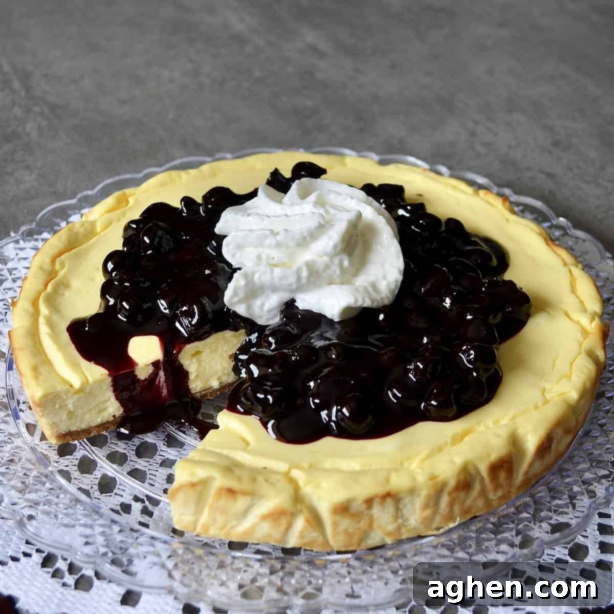 Smart Indulgence New York Cheesecake with Blueberry Compote 5 A slice of perfectly baked and decorated Weight Watchers New York Cheesecake on a plate, adorned with fresh berries