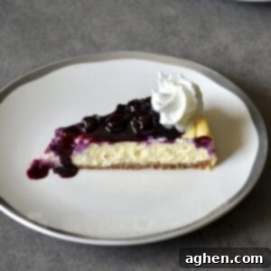 Smart Indulgence New York Cheesecake with Blueberry Compote 6 A perfectly sliced piece of Weight Watchers New York Cheesecake topped with fresh berries, showcasing its creamy texture