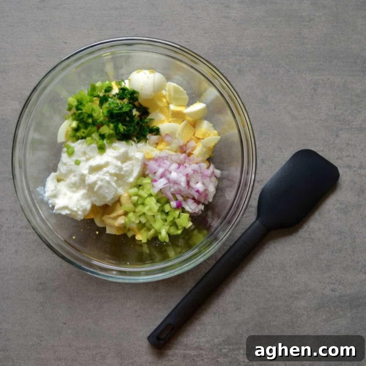 Light & Creamy Weight Watchers Egg Salad 4 Greek yogurt egg salad ingredients being mixed in a bowl