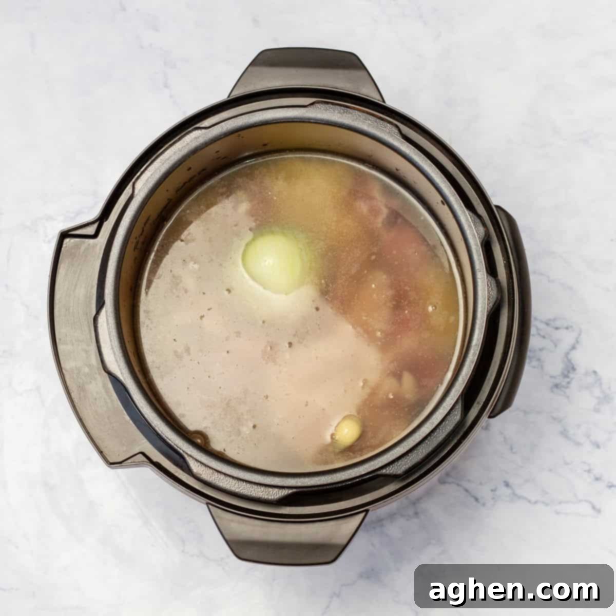 Light Pozole: All the Flavor, Less Guilt 4 Chicken, broth, aromatics, and spices cooking in the instant pot to prepare the chicken and broth.