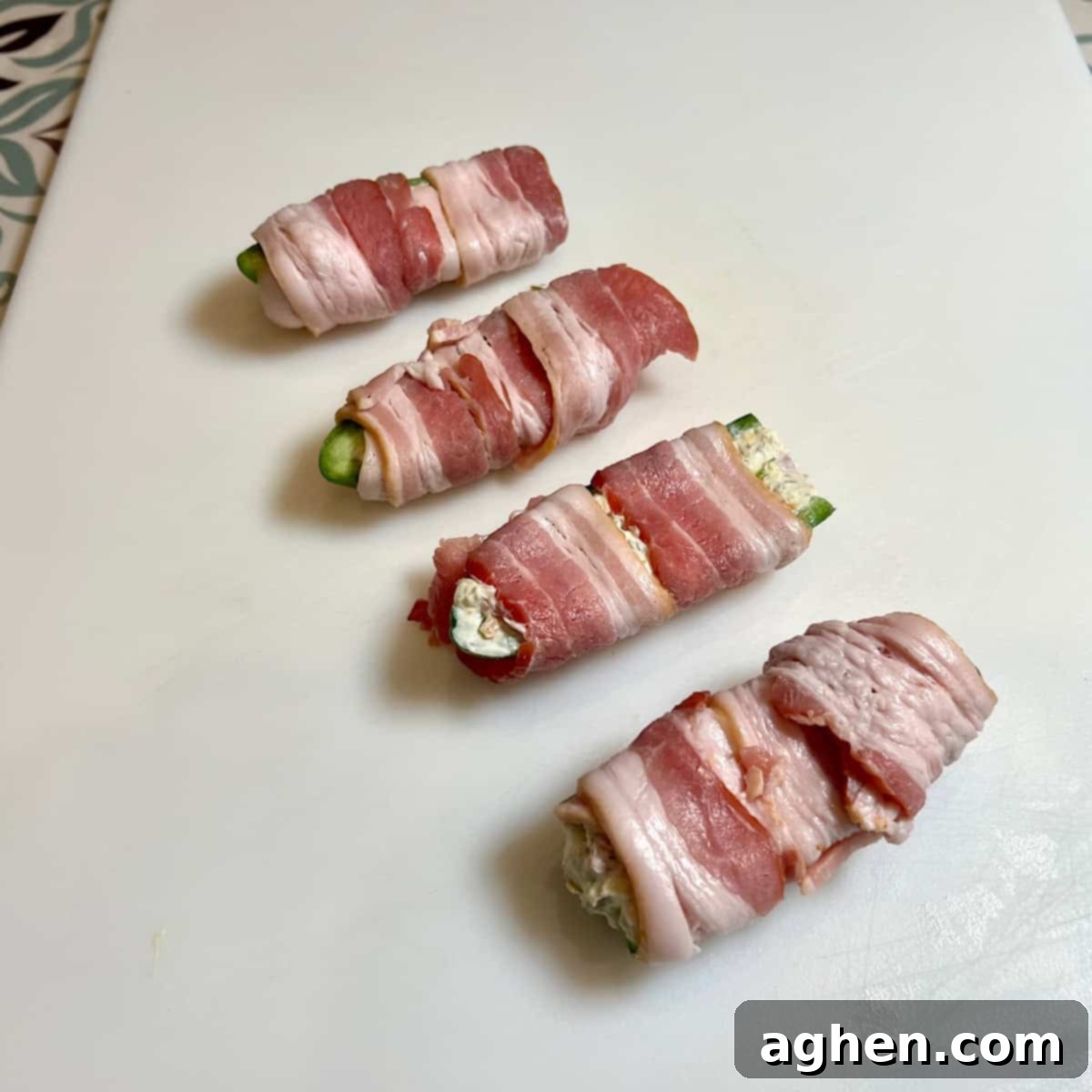 Competition BBQ Veteran's Smoked Bacon Wrapped Jalapeno Poppers 11 Bacon-wrapped jalapeno halves on a grill