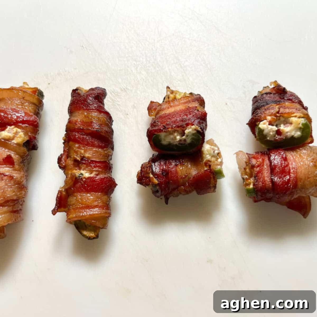 Competition BBQ Veteran's Smoked Bacon Wrapped Jalapeno Poppers 12 Close-up of bacon-wrapped jalapeno halves on a grill