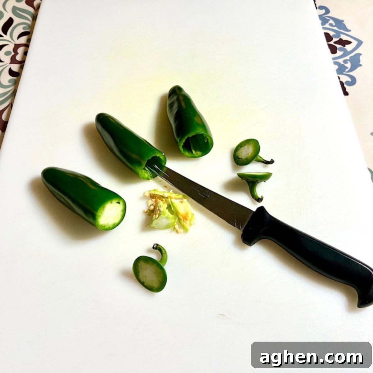 Competition BBQ Veteran's Smoked Bacon Wrapped Jalapeno Poppers 3 Preparing jalapenos by slicing off the top and hollowing out seeds and veins