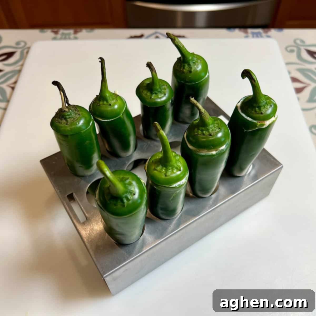 Competition BBQ Veteran's Smoked Bacon Wrapped Jalapeno Poppers 7 Stuffed jalapeno peppers placed upright in a popper holder