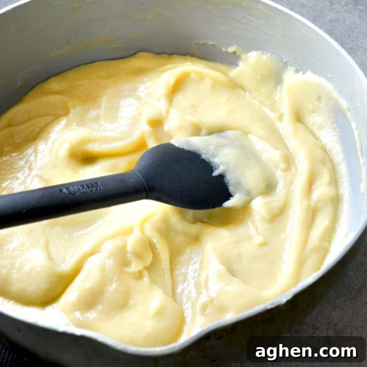 Light and Creamy Weight Watchers Banana Pudding 5 Thickened banana pudding cooking in a saucepan on the stove, showing its smooth and creamy consistency.