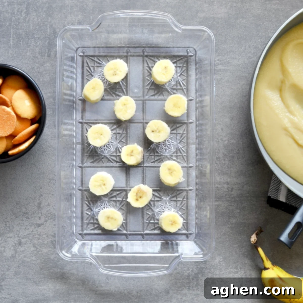 Light and Creamy Weight Watchers Banana Pudding 6 A baking dish with a layer of vanilla wafers and sliced bananas at the bottom, ready for the pudding to be added.