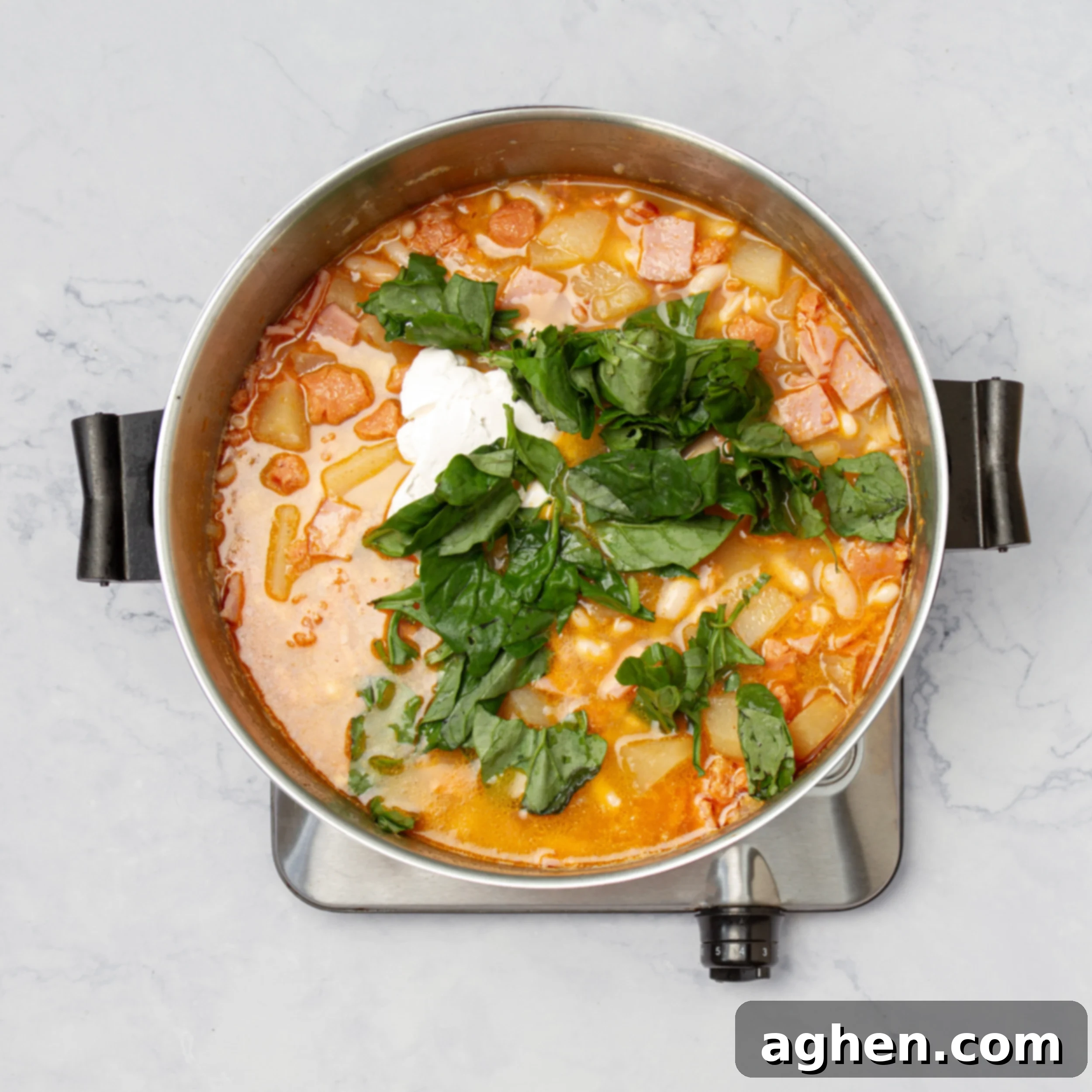 Mastering Olive Garden's Zuppa Toscana At Home 6 All soup ingredients simmering in a hot pot.