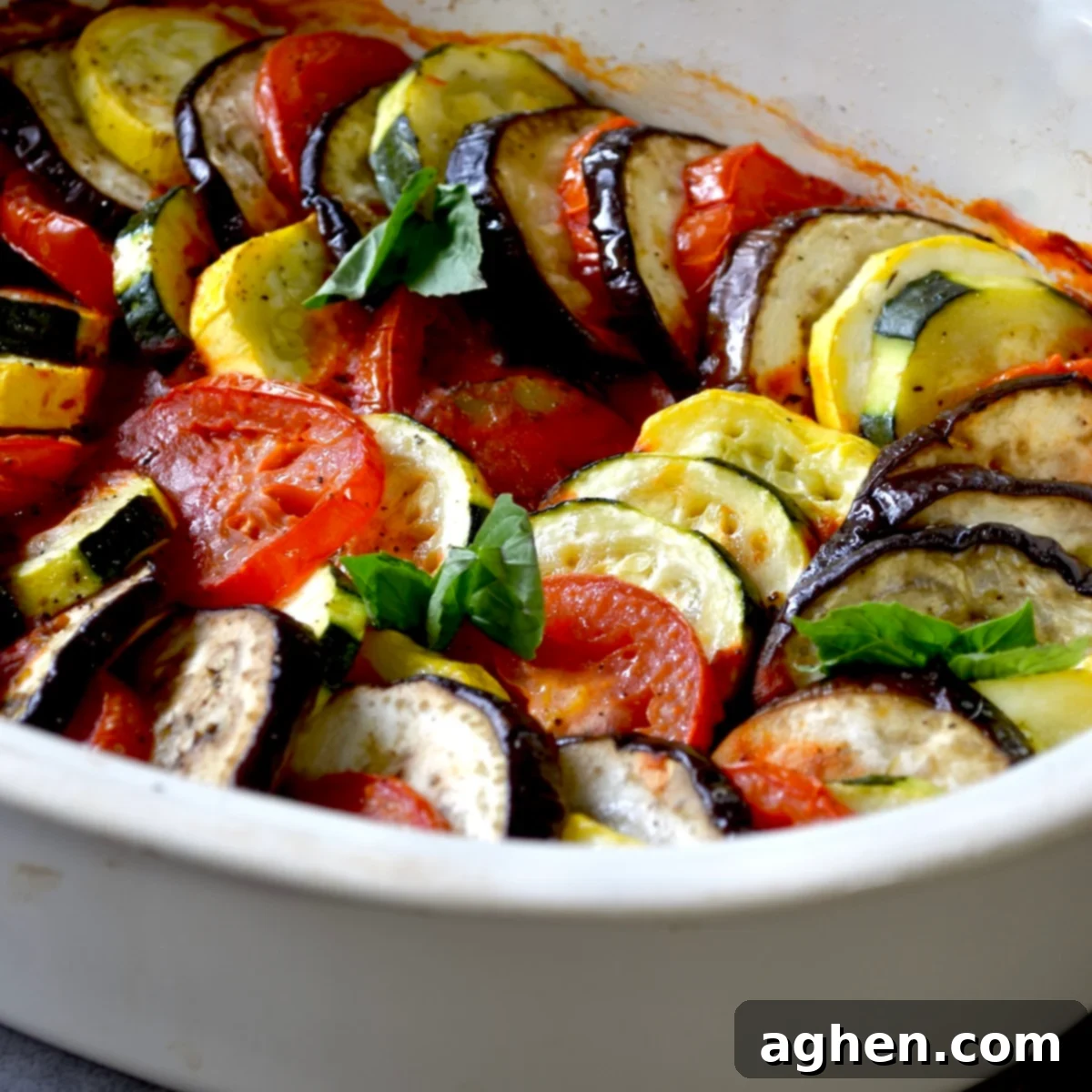 Late Summer Light Ratatouille Bake 2 Cooked ratatouille in a casserole dish, garnished with fresh basil.
