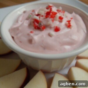 Festive Candy Cane Fruit Dip 2 A close-up shot of the creamy Candy Cane Fruit Dip, showing its light pink hue and bits of crushed candy cane mixed in.