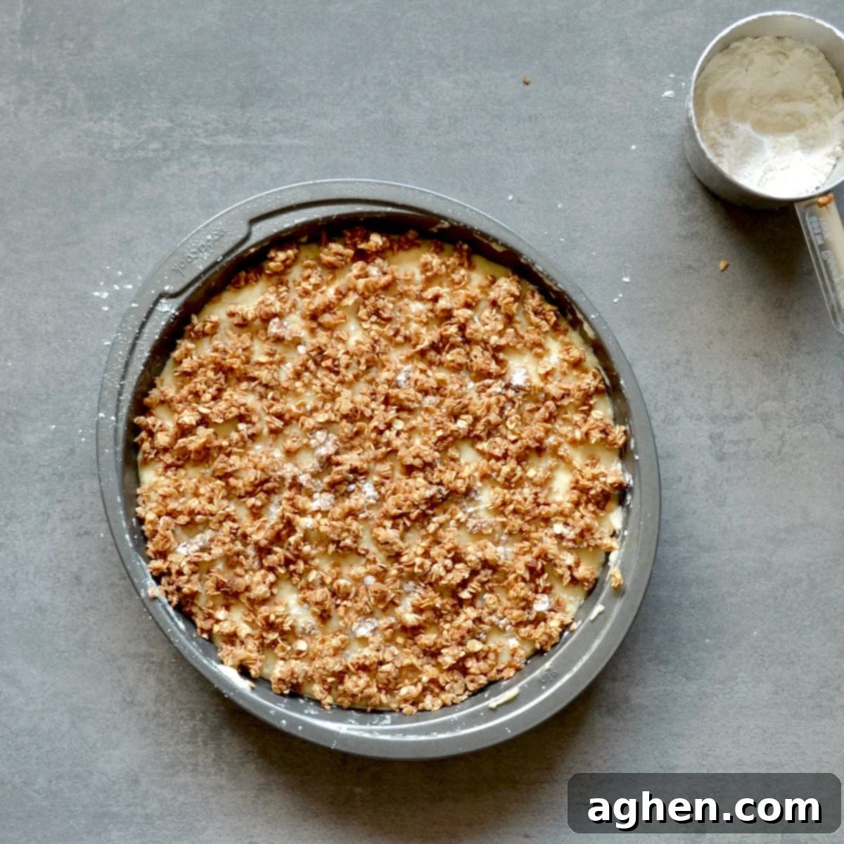 Weight Watchers Friendly Brown Sugar Oat Coffee Cake Perfection 6 Unbaked coffee cake with smooth batter topped with a generous, even layer of brown sugar oat mixture in a square baking dish, ready for the oven.
