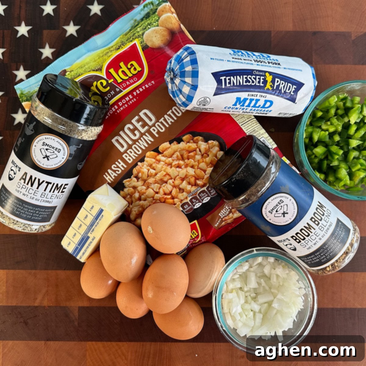 The Ultimate Griddle Breakfast Hash Recipe 3 Ingredients laid out for breakfast hash: frozen hash browns, onion, green pepper, sausage, eggs, and spice blends.