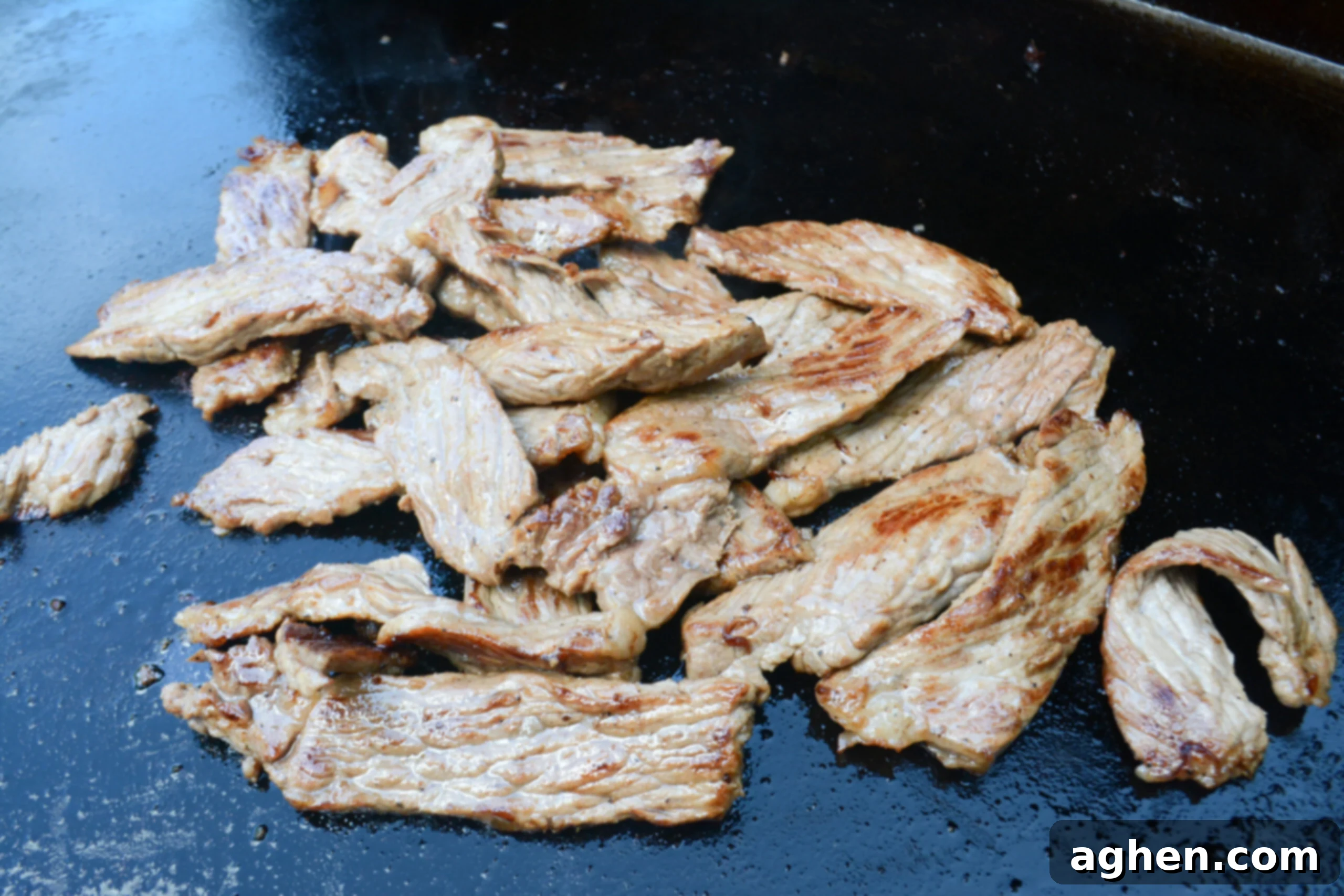 Blackstone Steak Quesadillas So Good They're Eaten Off the Griddle 7 cooked steak slices on the blackstone griddle.