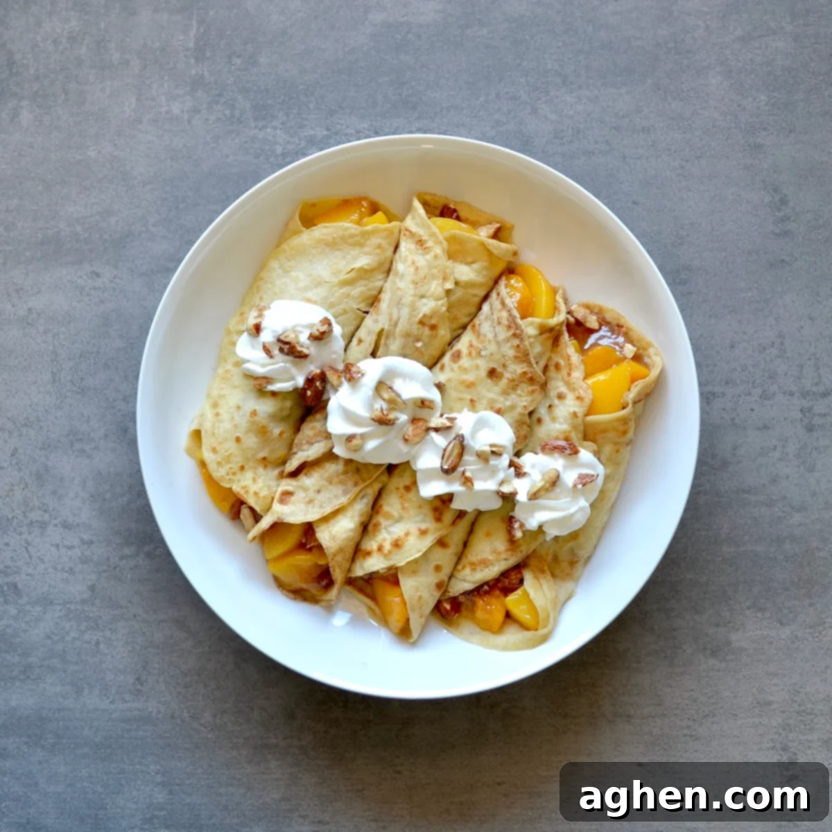 Golden Peach Crepes with Toasted Almond Crunch 2 Crepes with peaches and almonds