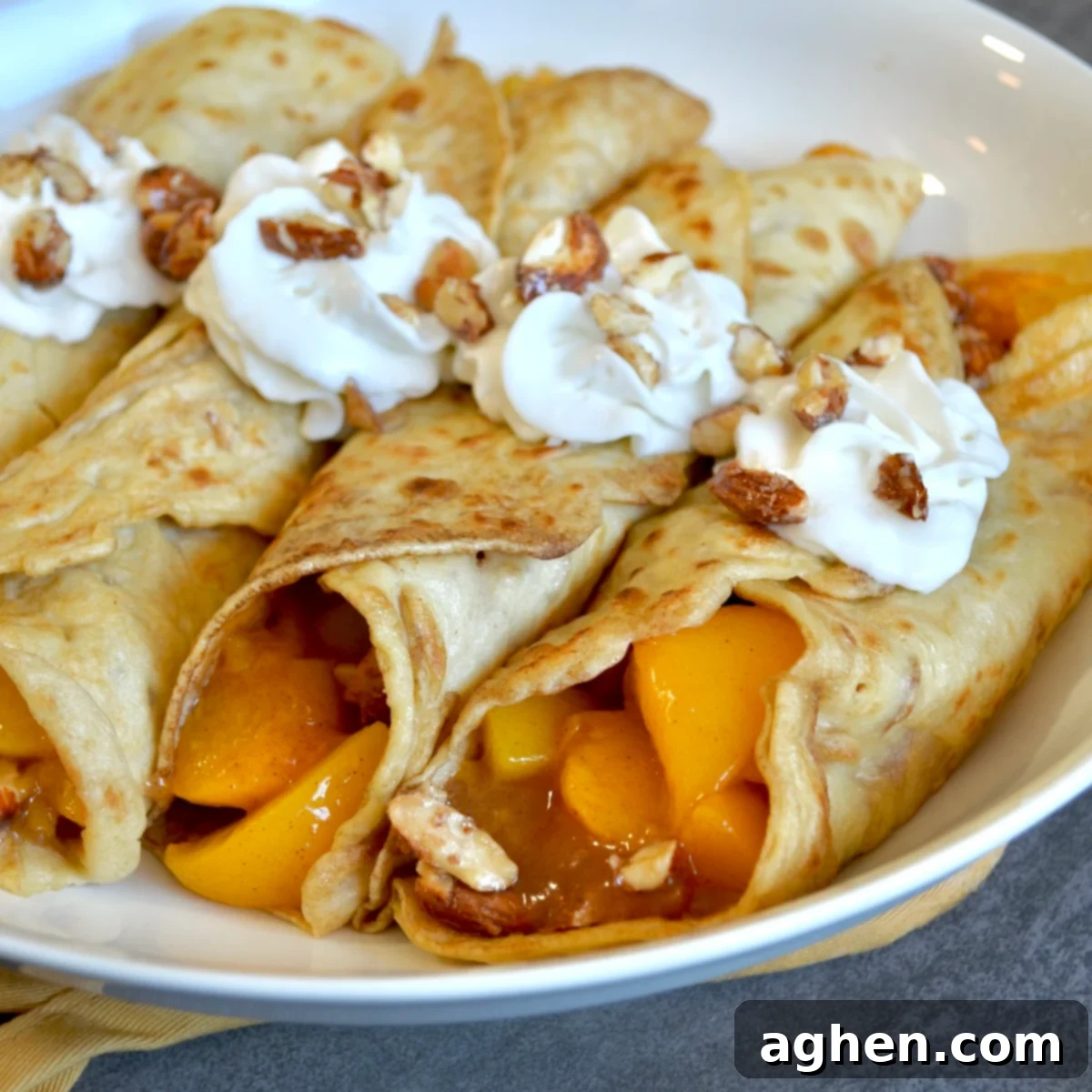 Golden Peach Crepes with Toasted Almond Crunch 6 Crepes with peach filling and whipped cream