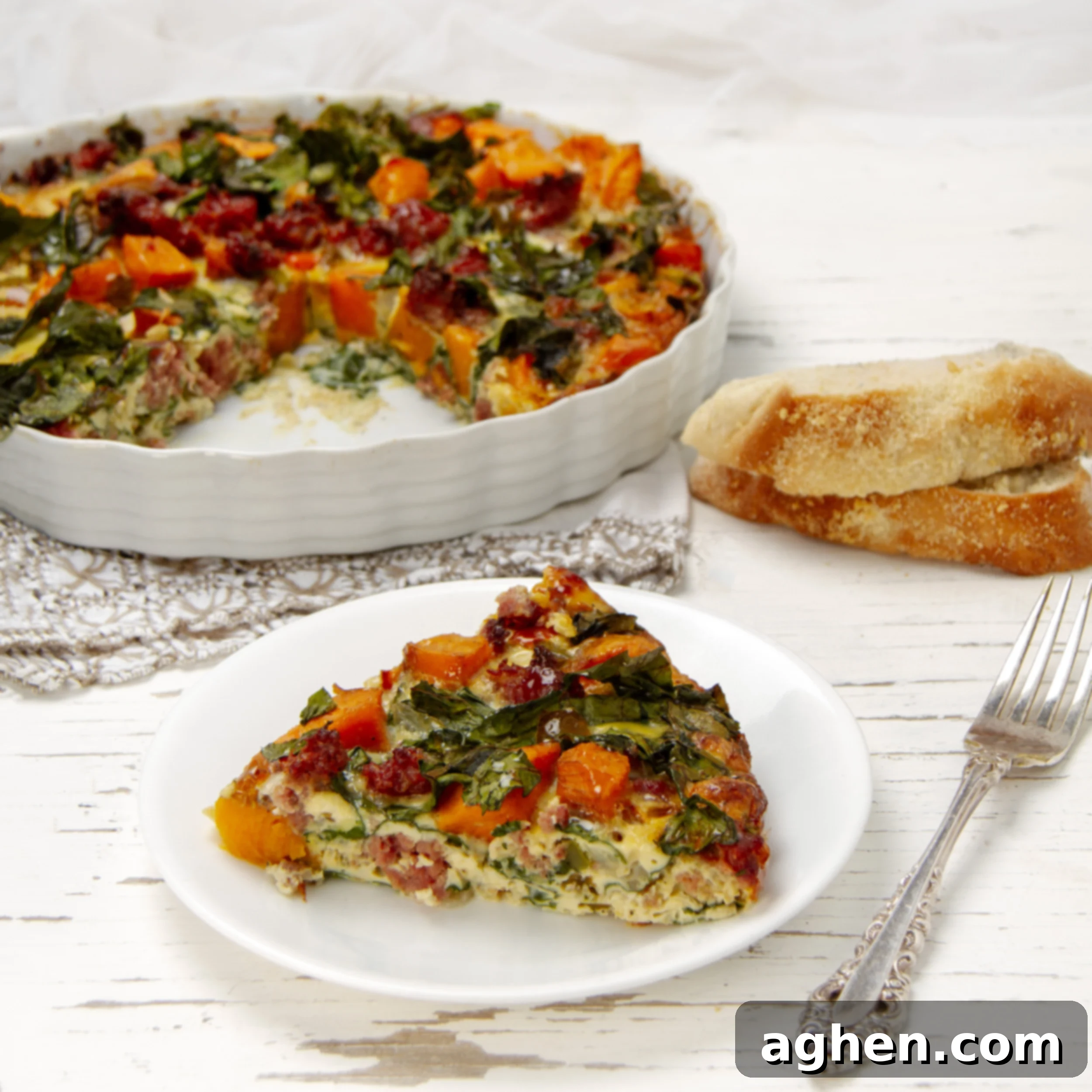 Smart Start: Weight Watchers Breakfast Casseroles for Any Gathering 8 A beautiful slice of Sweet Potato Sausage Breakfast Casserole, served on a white plate with a fork.