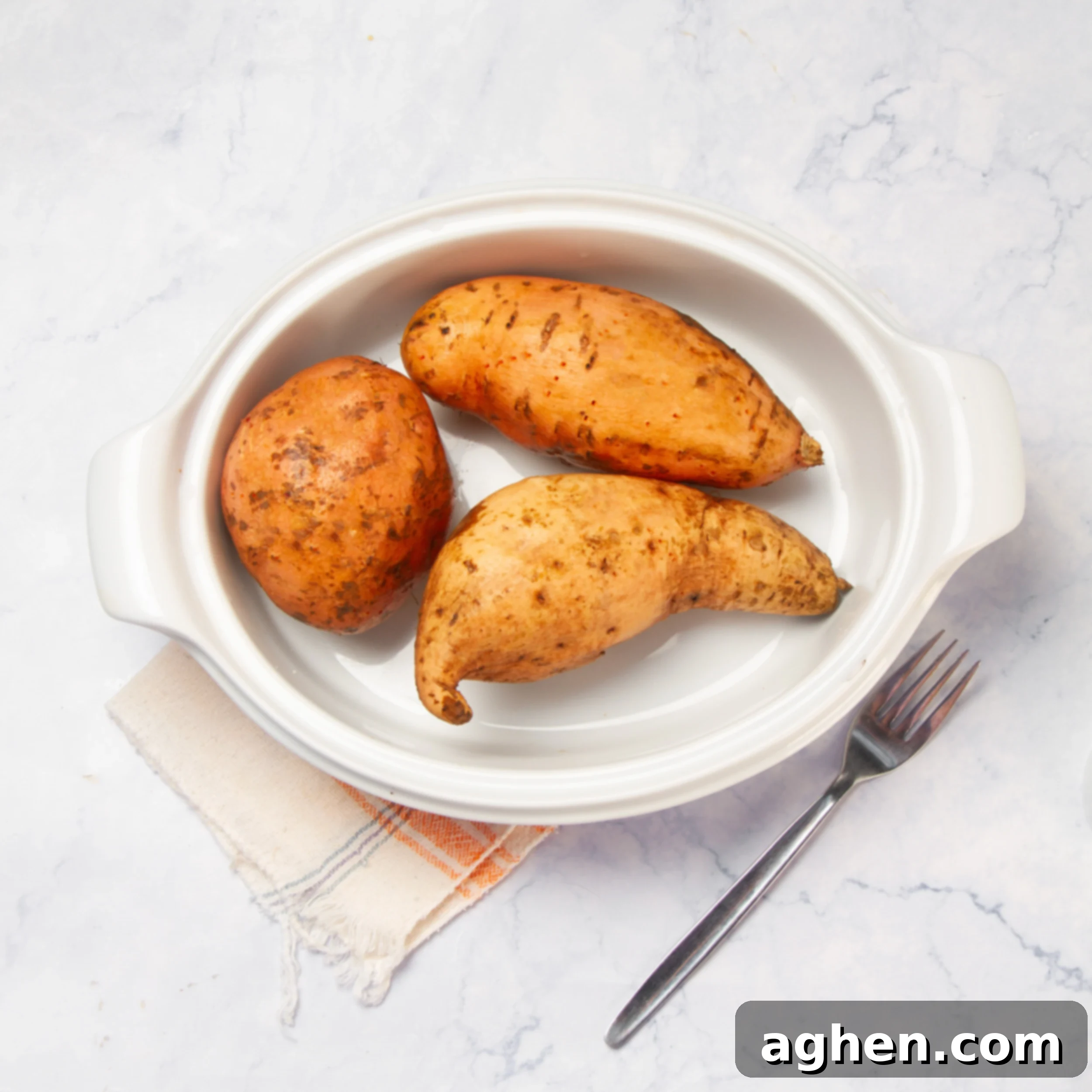 Ultimate Twice-Baked Sweet Potatoes 4 Cooked sweet potatoes on a plate.