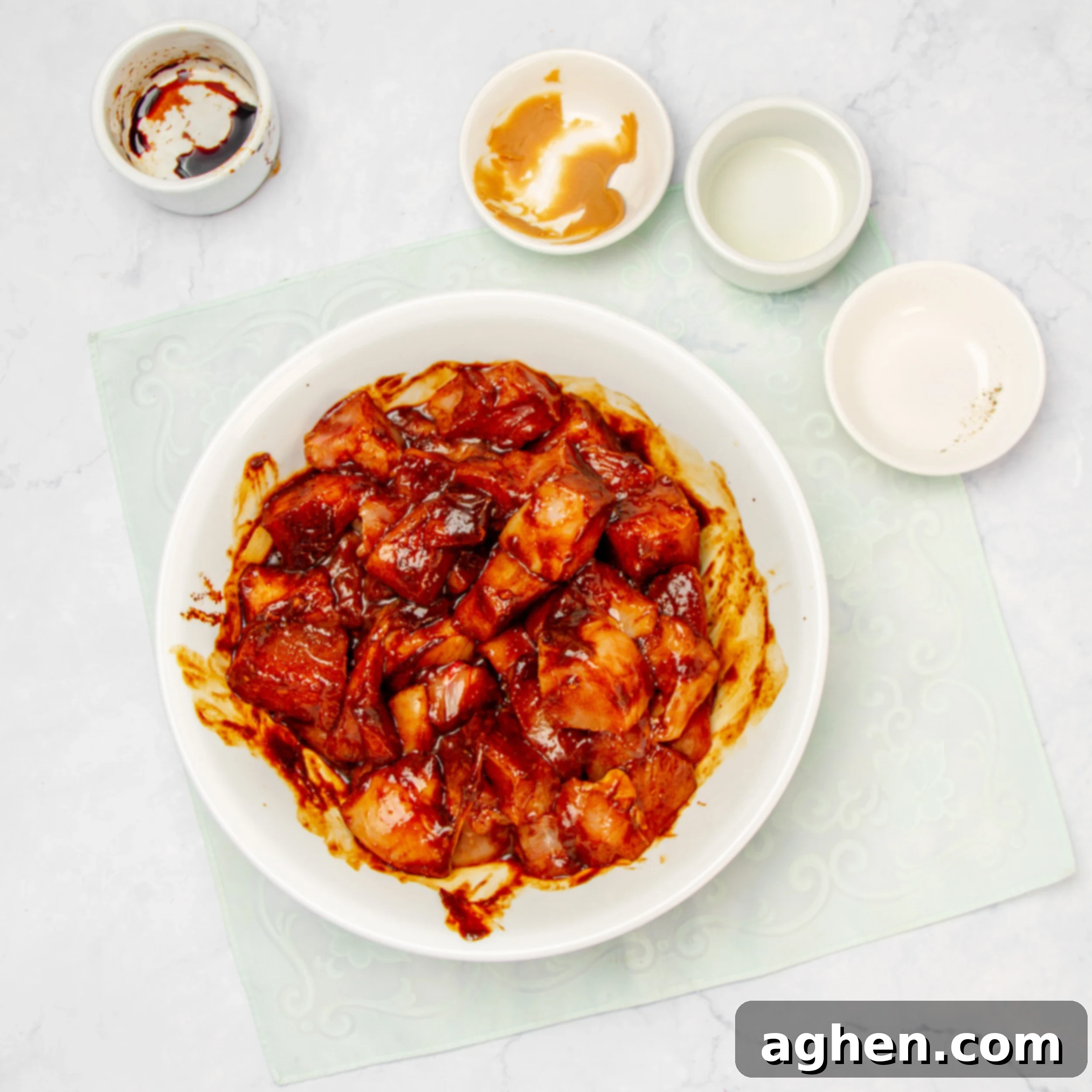 Flavorful Chicken Satay Skewers 4 Marinating the chicken in the savory satay sauce within a bowl.