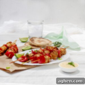 Flavorful Chicken Satay Skewers 7 Bold, Asian-inspired Chicken Satay Skewers on a plate.