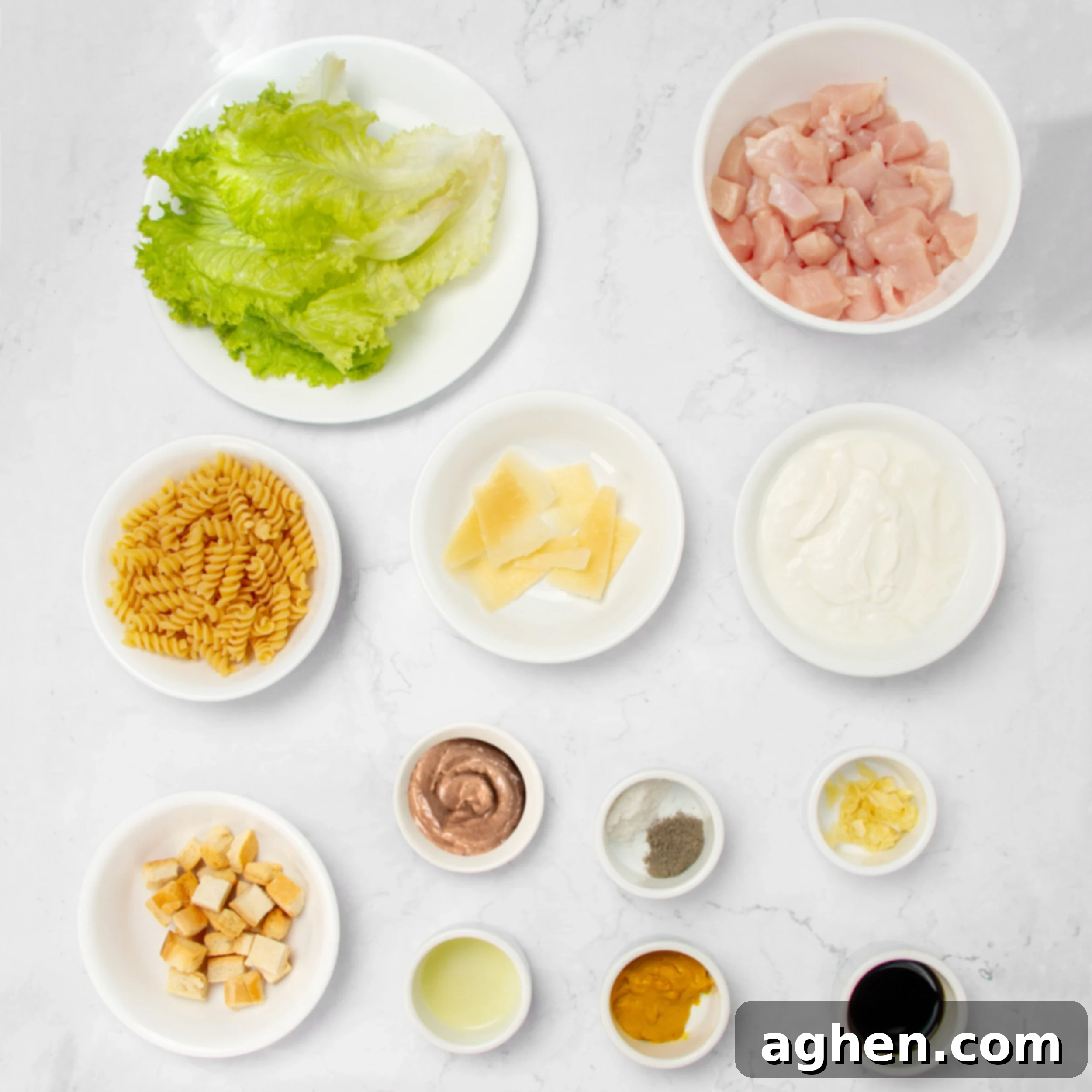 Weight Watchers' Iconic Chicken Caesar Pasta Salad 3 Healthy and vibrant Chicken Caesar Pasta Salad ingredients in separate dishes.