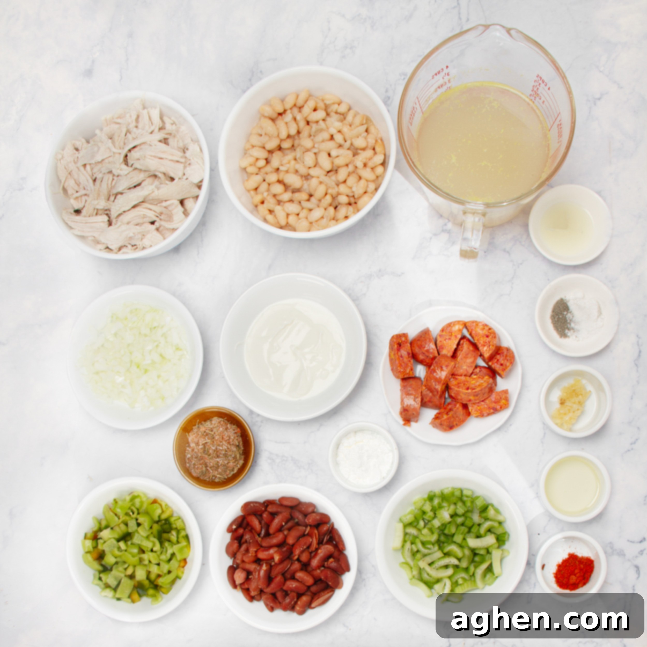 Creamy Cajun Chicken Chili 3 All the fresh ingredients for Cajun white chicken chili neatly arranged in separate dishes on a clean kitchen countertop, ready for preparation.