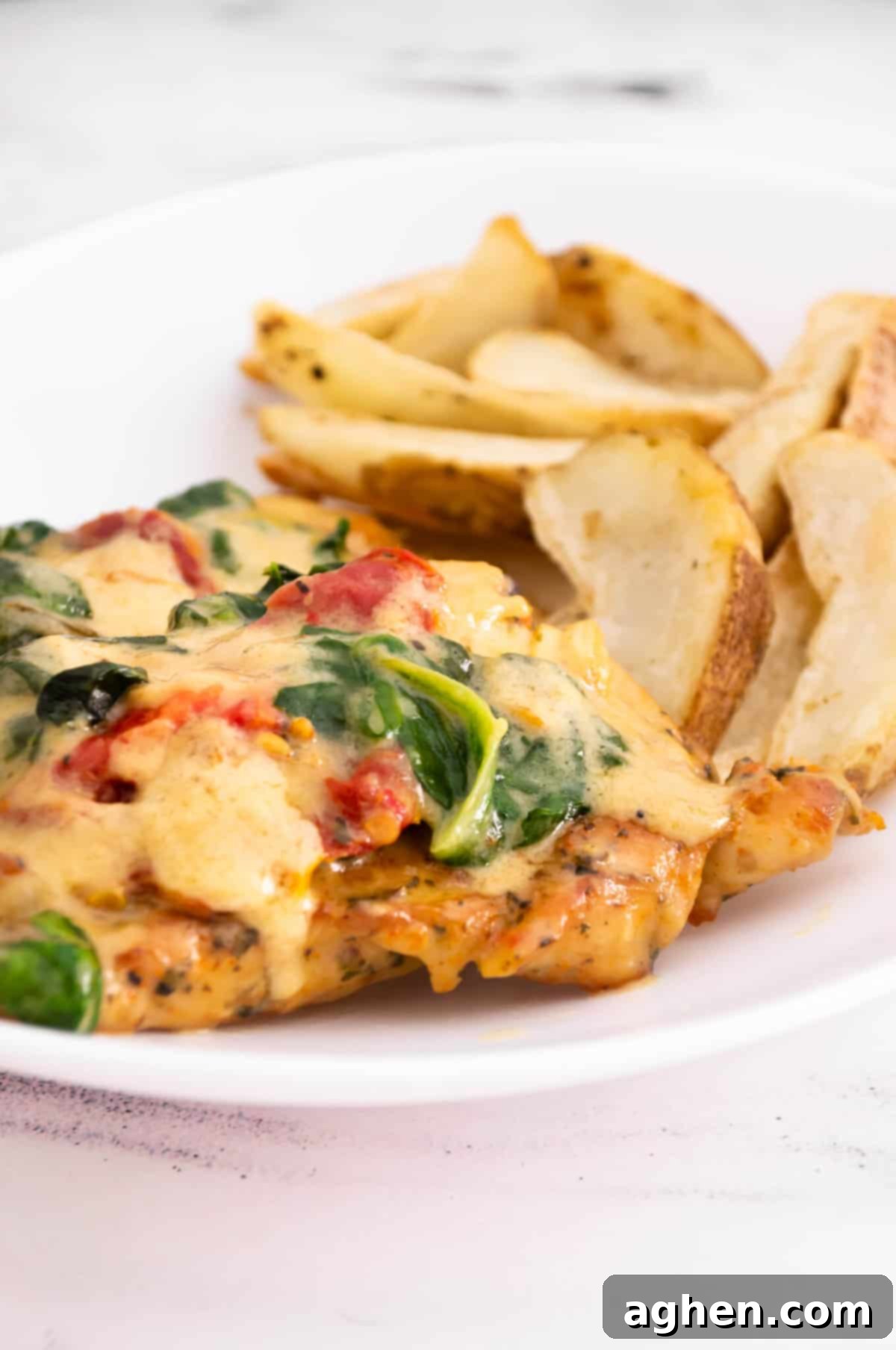 baked tuscan chicken and potatoes close up