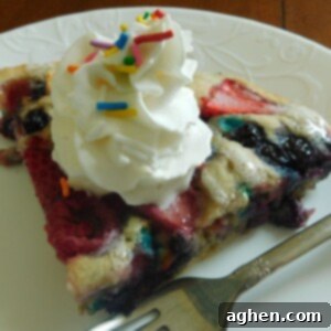 Confetti Berry Pancake Delight 2 A whole Berry Funfetti Pancake Pie in a round baking dish, with a light icing drizzle.