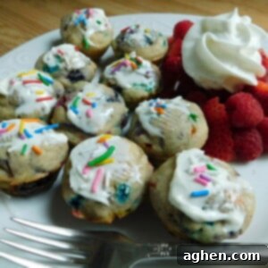 Celebration Sprinkle Muffins 2 Mini Funfetti muffins with a fork and white plate, showcasing vibrant sprinkles