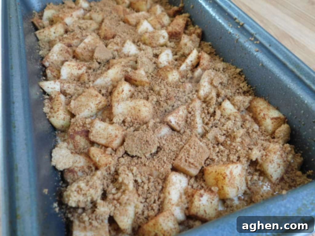 Cinnamon Swirl Apple Fritter Bread 4 Close-up of a slice of Apple Fritter Bread, showing apple pieces and glaze