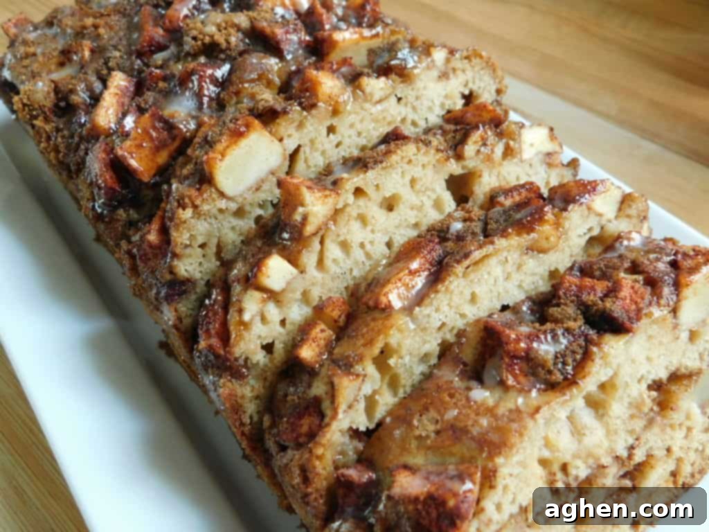 Cinnamon Swirl Apple Fritter Bread 6 A whole Apple Fritter Bread loaf on a wooden cutting board