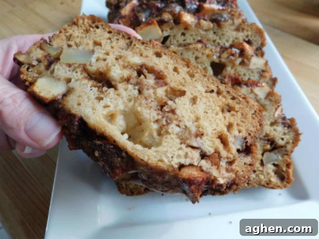 Cinnamon Swirl Apple Fritter Bread 8 Sliced Apple Fritter Bread with a fork, ready to be enjoyed