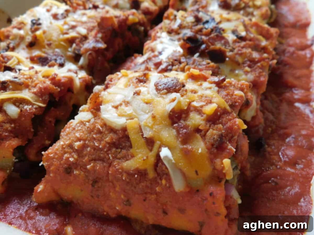 Ultimate Bacon Cheeseburger Lasagna Rolls 7 Close-up of baked Bacon Cheeseburger Lasagna Rolls topped with cheese