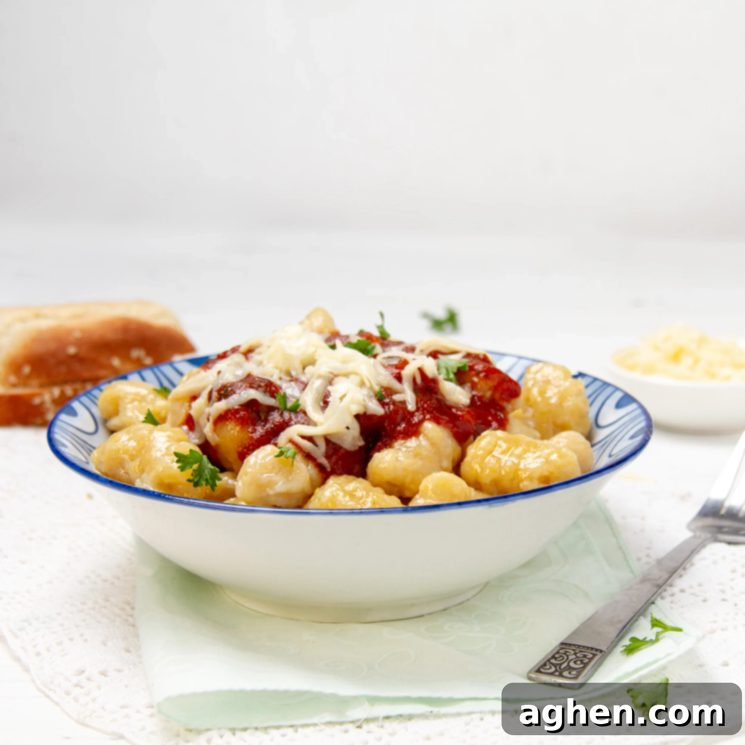 Soft and flavorful pumpkin gnocchi with sauce and cheese in a bowl.