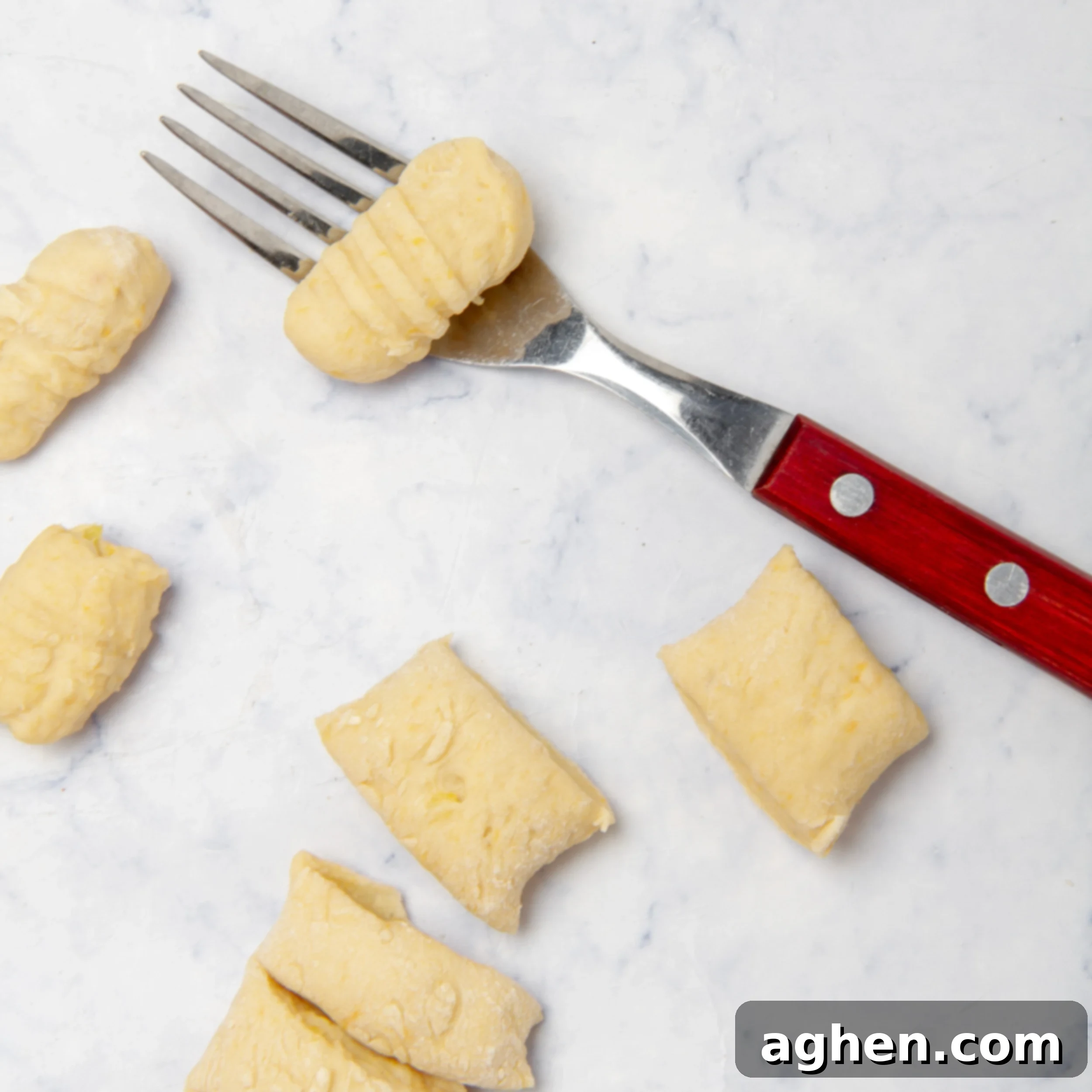 Using a fork to add indentations to the individual pieces of gnocchi. 